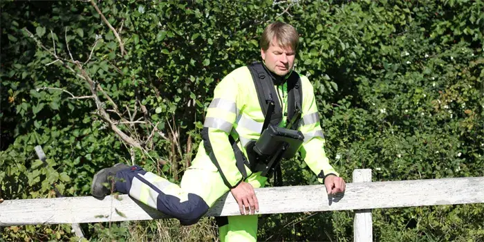 Young man climbs a fence